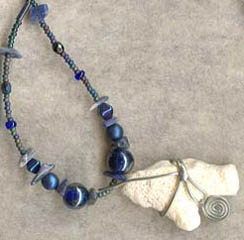 nickel-silver wire wrap over found stone as centerpiece in necklace - Czech firepolished beads accent the strand
