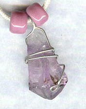 silver wrap over amethyst crystal point, strung on cotton cord with crow bead accents