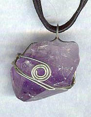 Amethyst crystal point wrapped in nickel-silver wire; on adjustable cotton cord