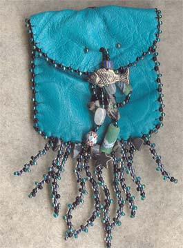 blue-dyed buckskin medicine bag with pewter fish, rainbow moonstone gemchips, sandcast trade beads, beaded stitching and fringe