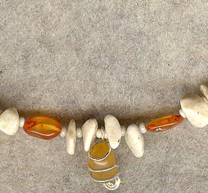 Howlite strand with carnelian highlights.  Centerpiece is a piece of carnelian agate